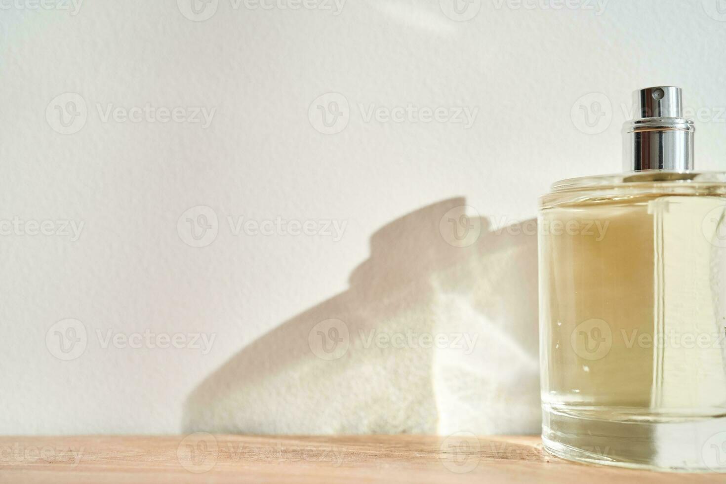 A bottle of perfume in the rays of the sun. photo