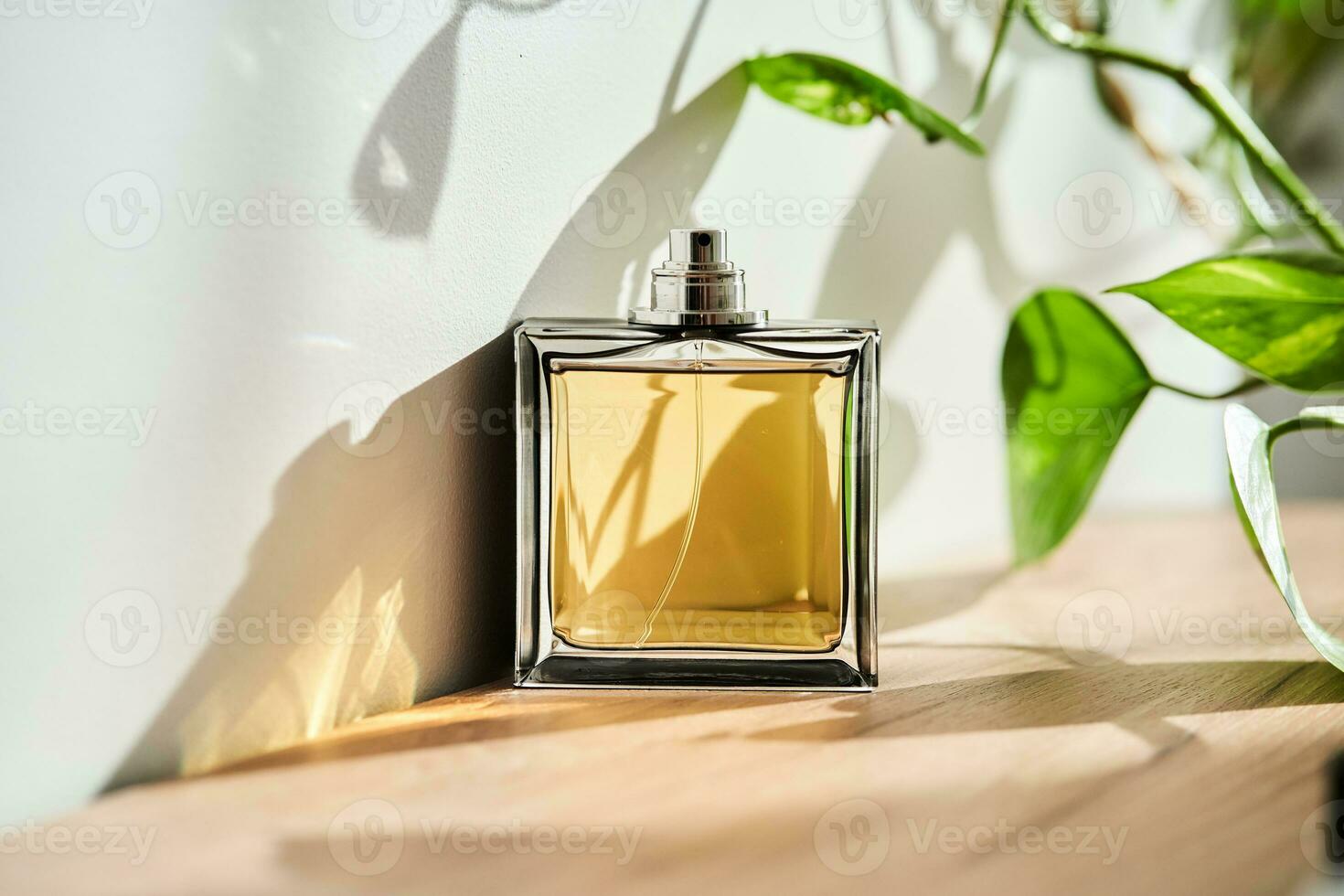 A bottle of perfume in the rays of the sun. photo