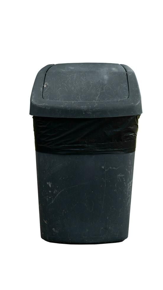 Background and textured of old black plastic trash bin with a black garbage bag lining. Container with a lid that can be rotated. with clipping path. photo