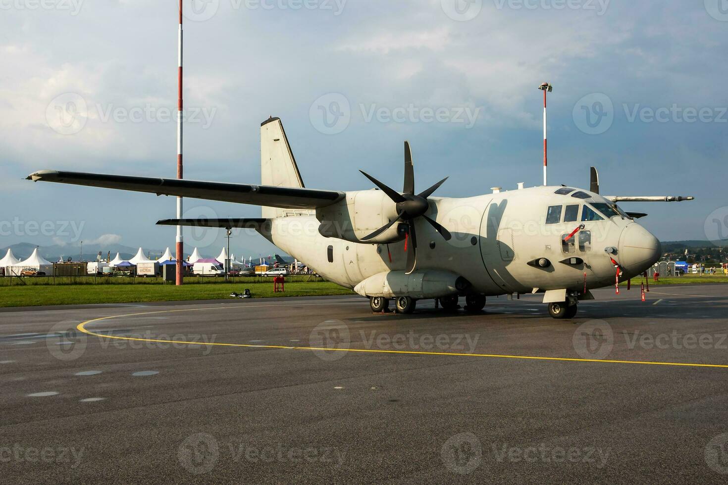 Untitled military transport plane at air base. Airport and airfield. Air force and army flight operation. Aviation and aircraft. Air lift. Military industry. Fly and flying. photo