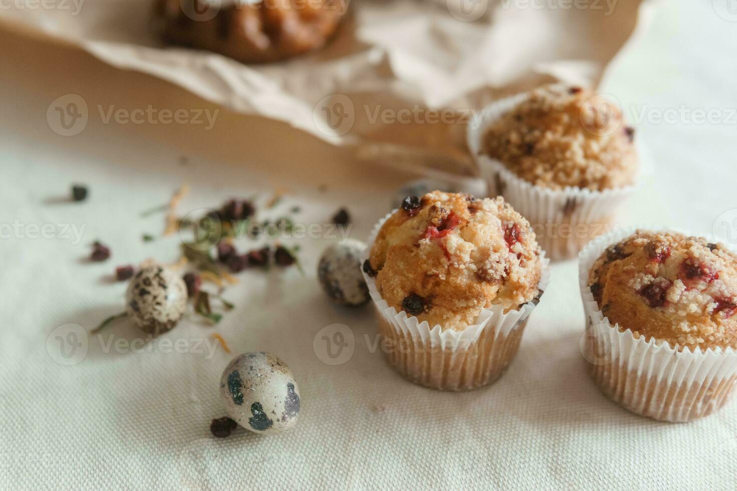 Easter cupcakes with raisins and quail eggs on a white table close-up. The concept of celebrating Happy Easter. photo