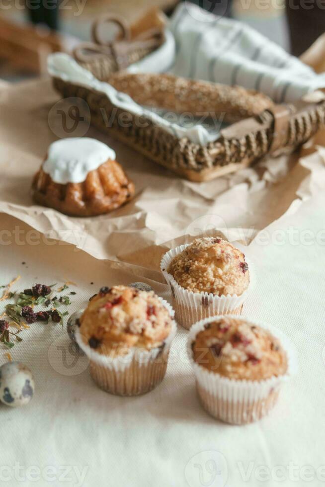 Easter cupcakes with raisins and quail eggs on a white table close-up. The concept of celebrating Happy Easter. photo