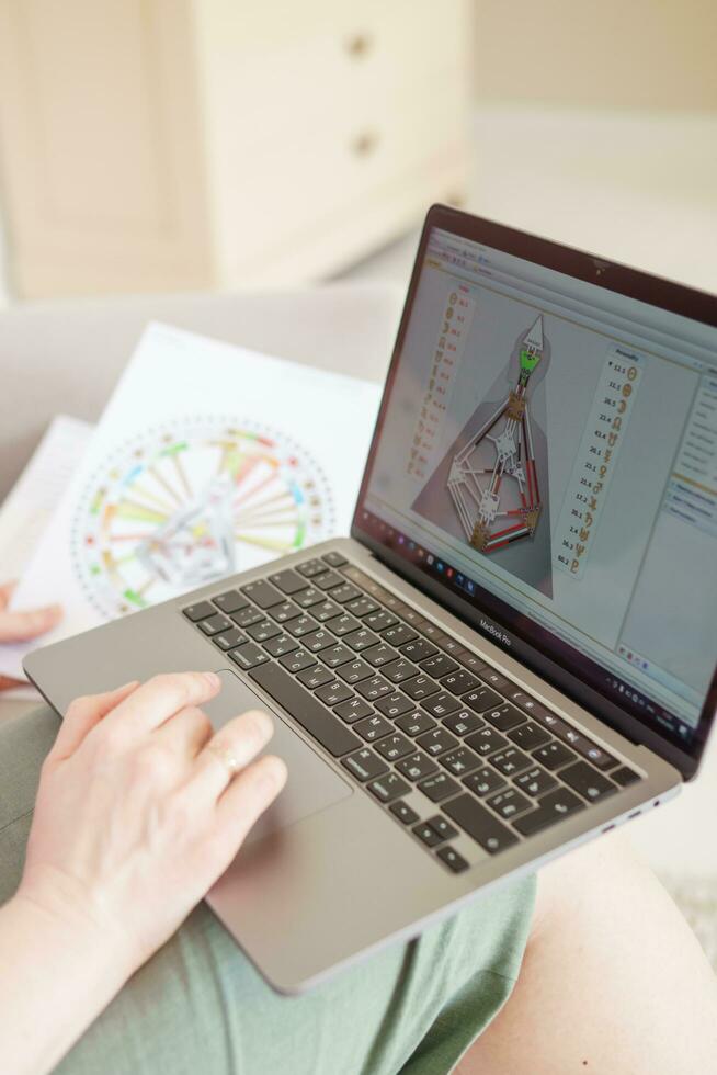 Tver, Russia-august 7, 2022. A woman with a laptop is studying human design. The concept of studying esoteric sciences. Studying rave postcards from human design photo