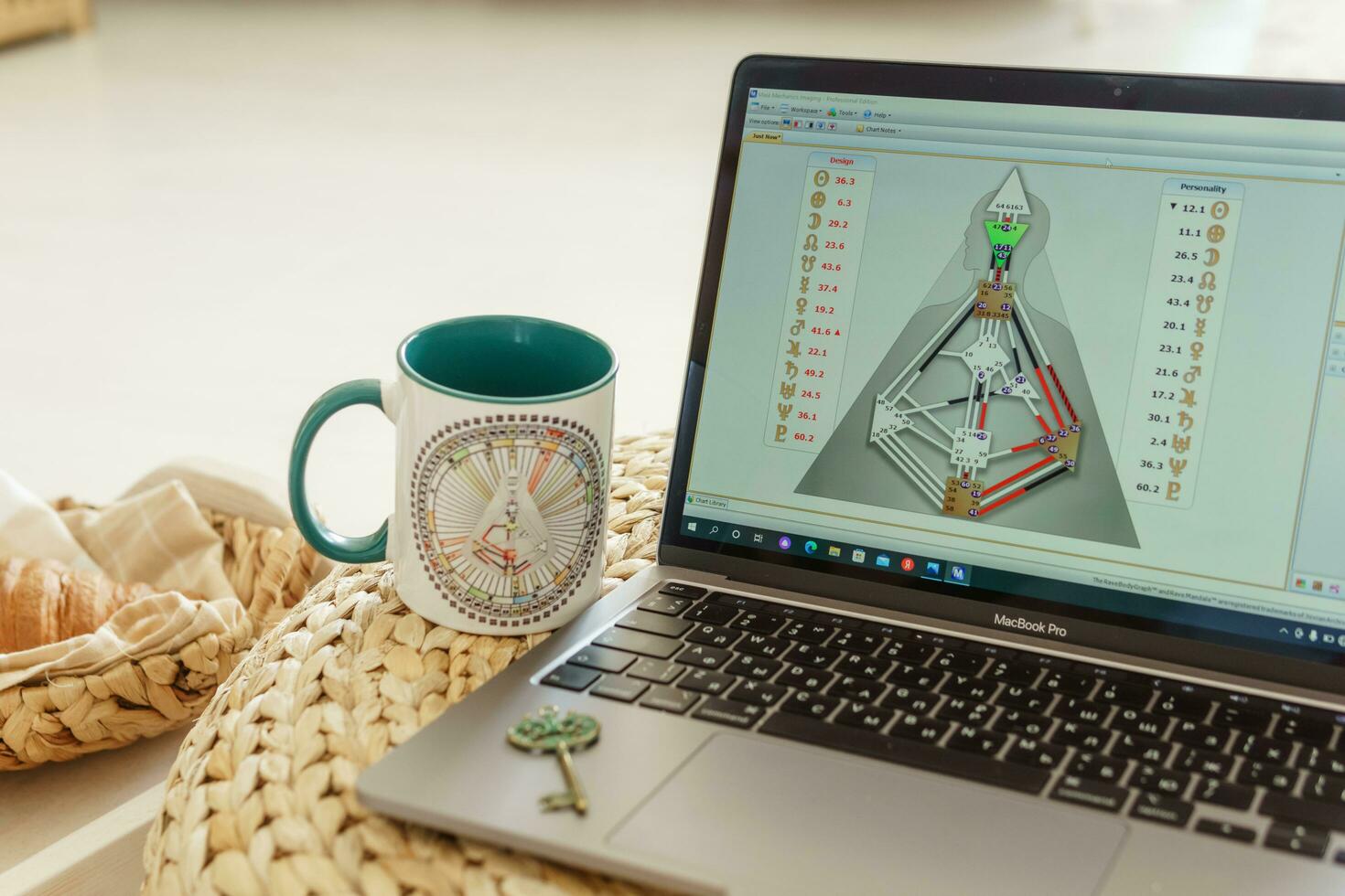 Tver, Russia-august 7, 2022. laptop is studying human design. The concept of studying esoteric sciences. Studying rave postcards from human design photo