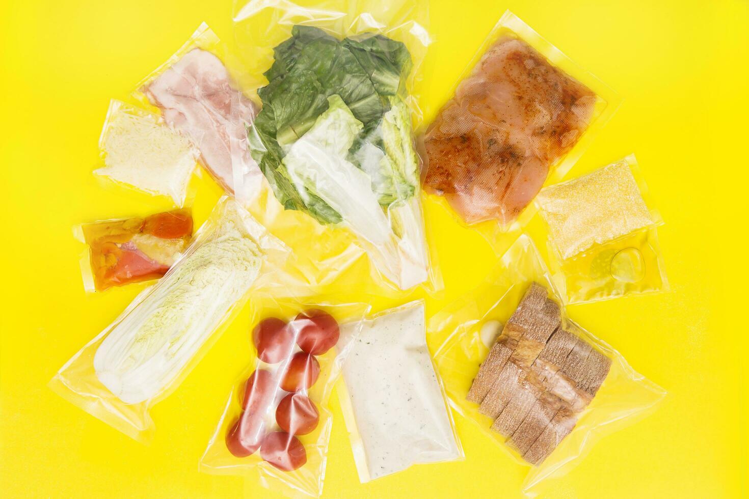 Hands holding bags of food. Salad dinner set. chicken, lettuce, tomatoes, peking cabbage, cheese, bacon, bread, olive oil sauces and spices. A set for delivering food photo