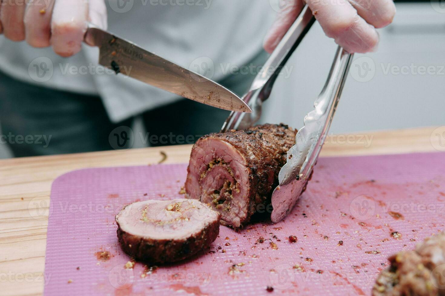 Cooking meat rolls in the cooking class. Beef roll with spices. The process of cutting a roll, close-up. photo
