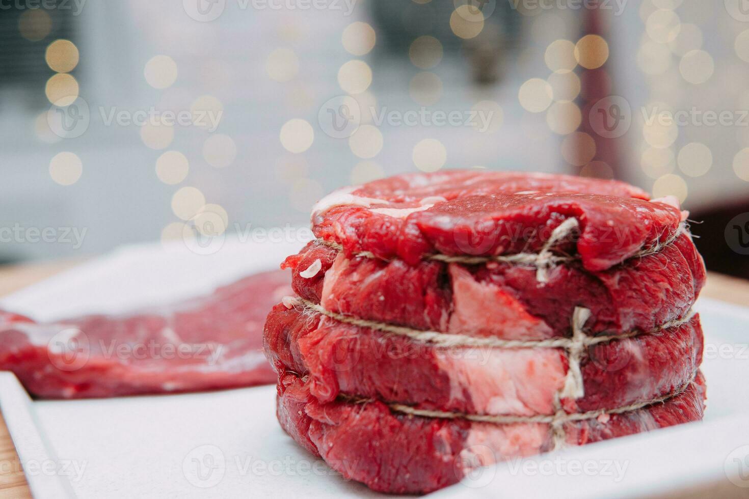 A piece of aged beef on a plate. Meat for steaks in a cooking class. photo