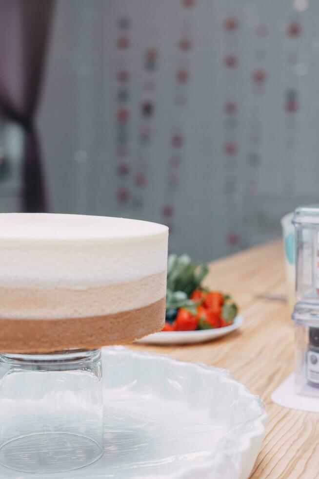 A piece of chocolate cake in the cut. Preparation of mousse cake at a culinary master class. Cooking at home, homemade food photo
