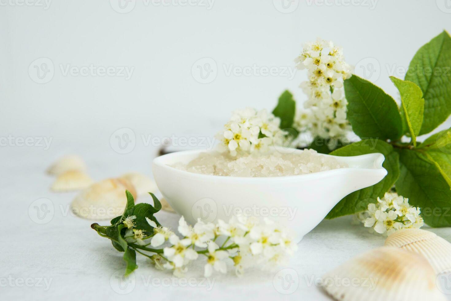 Concept of Spa-cosmetic and cosmetic procedures. Spa-sea salt in white dishes and seashells on light concrete background. The concept of a waste-free lifestyle. copyspase. photo