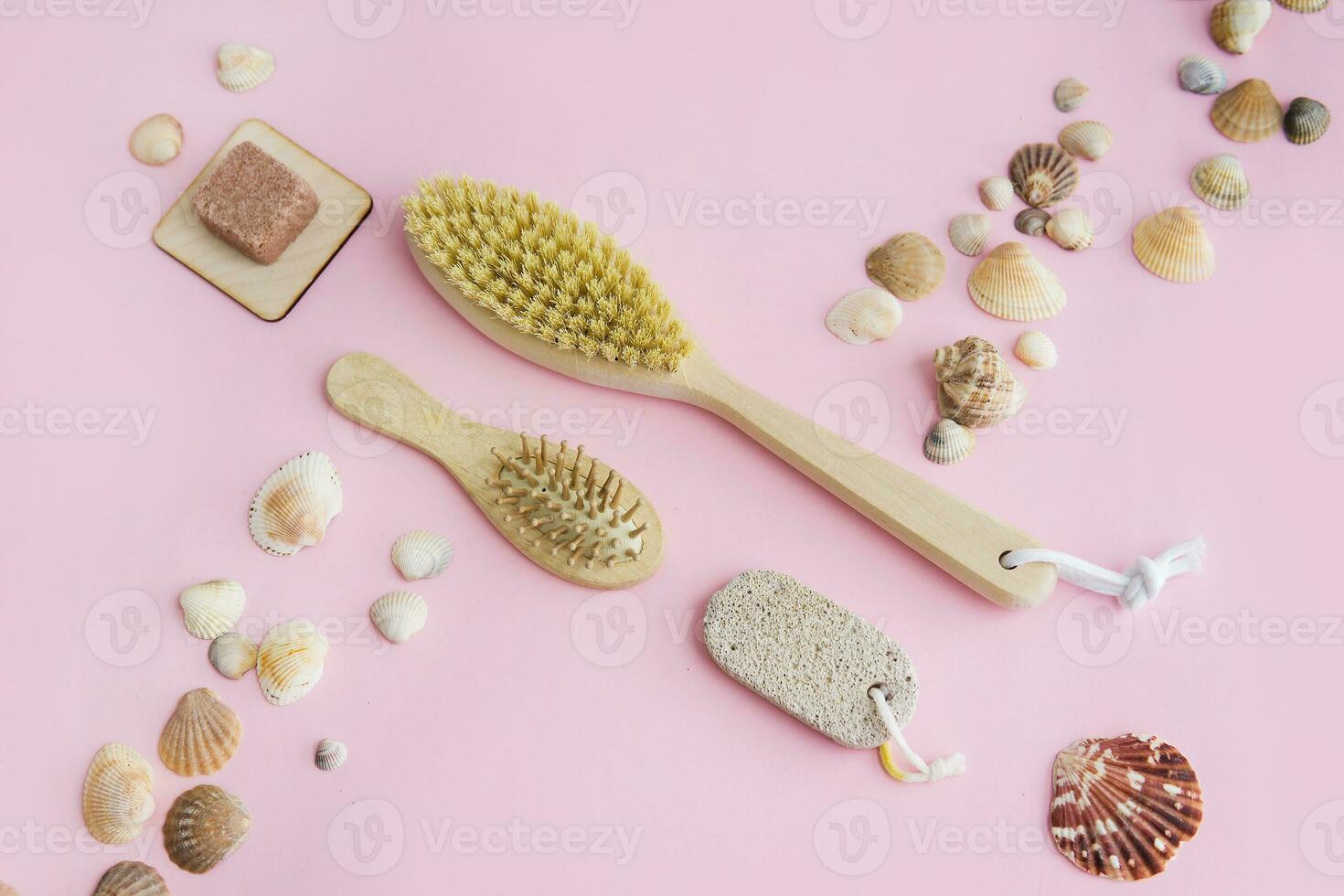 Concept of Spa-cosmetic and cosmetic procedures. Spa-sea salt, wooden comb, anti-cellulite massage brush on a pink background. The concept of a waste-free lifestyle. photo