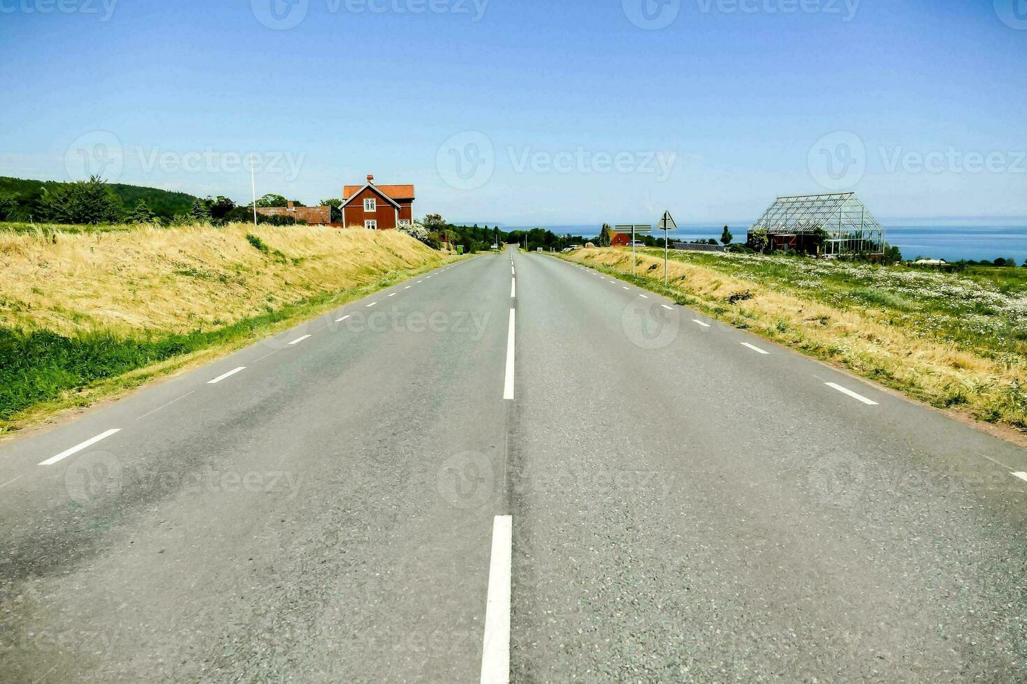 an empty road with a house on the side photo