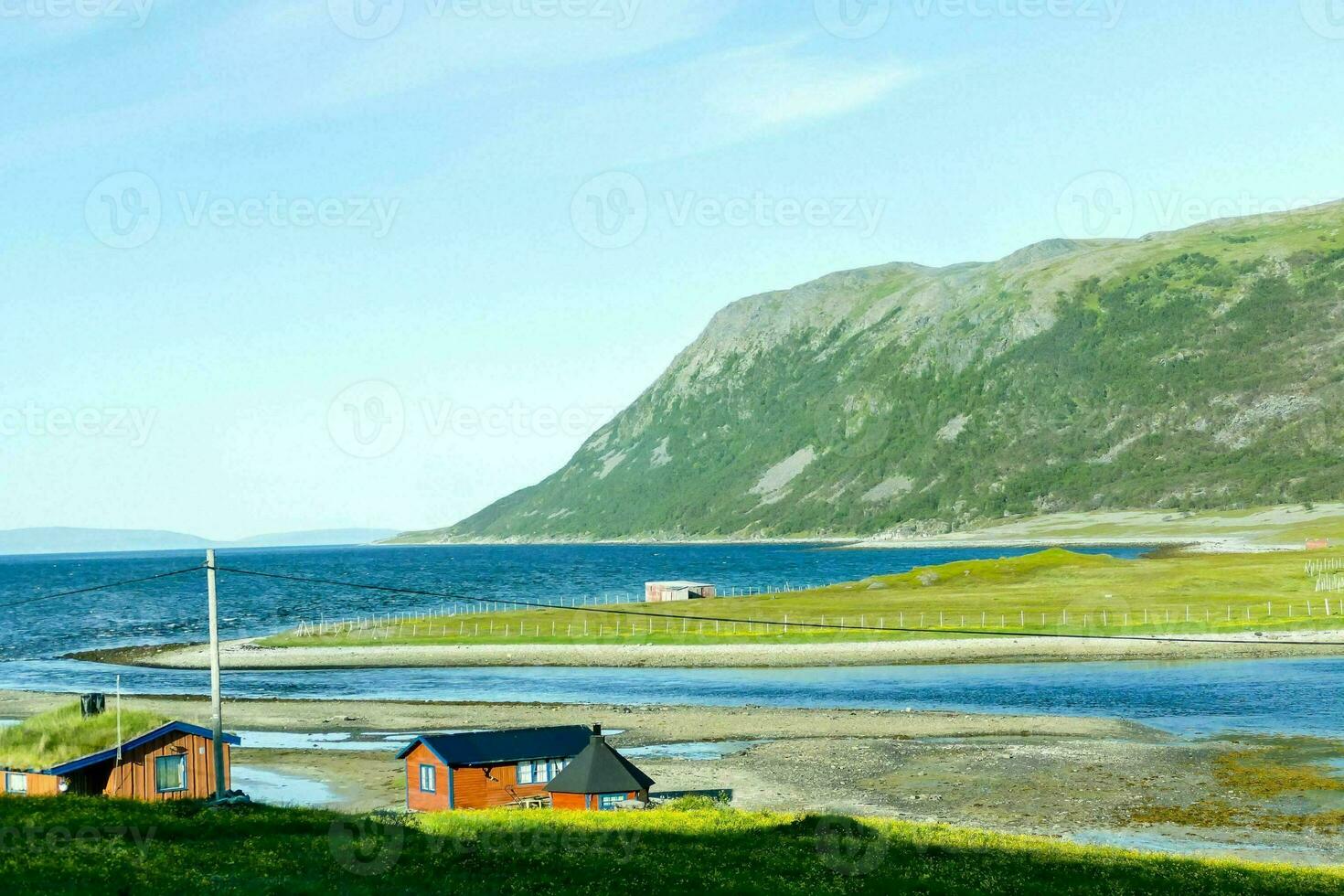 a small village on the shore of the ocean photo