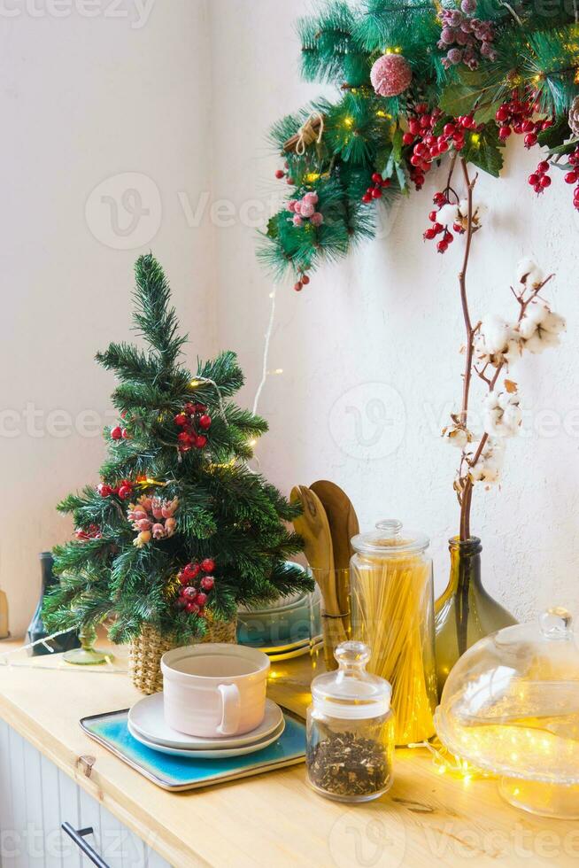 Kitchen interior decorated for Christmas and New Year. New Year's interior in red and white tones. photo