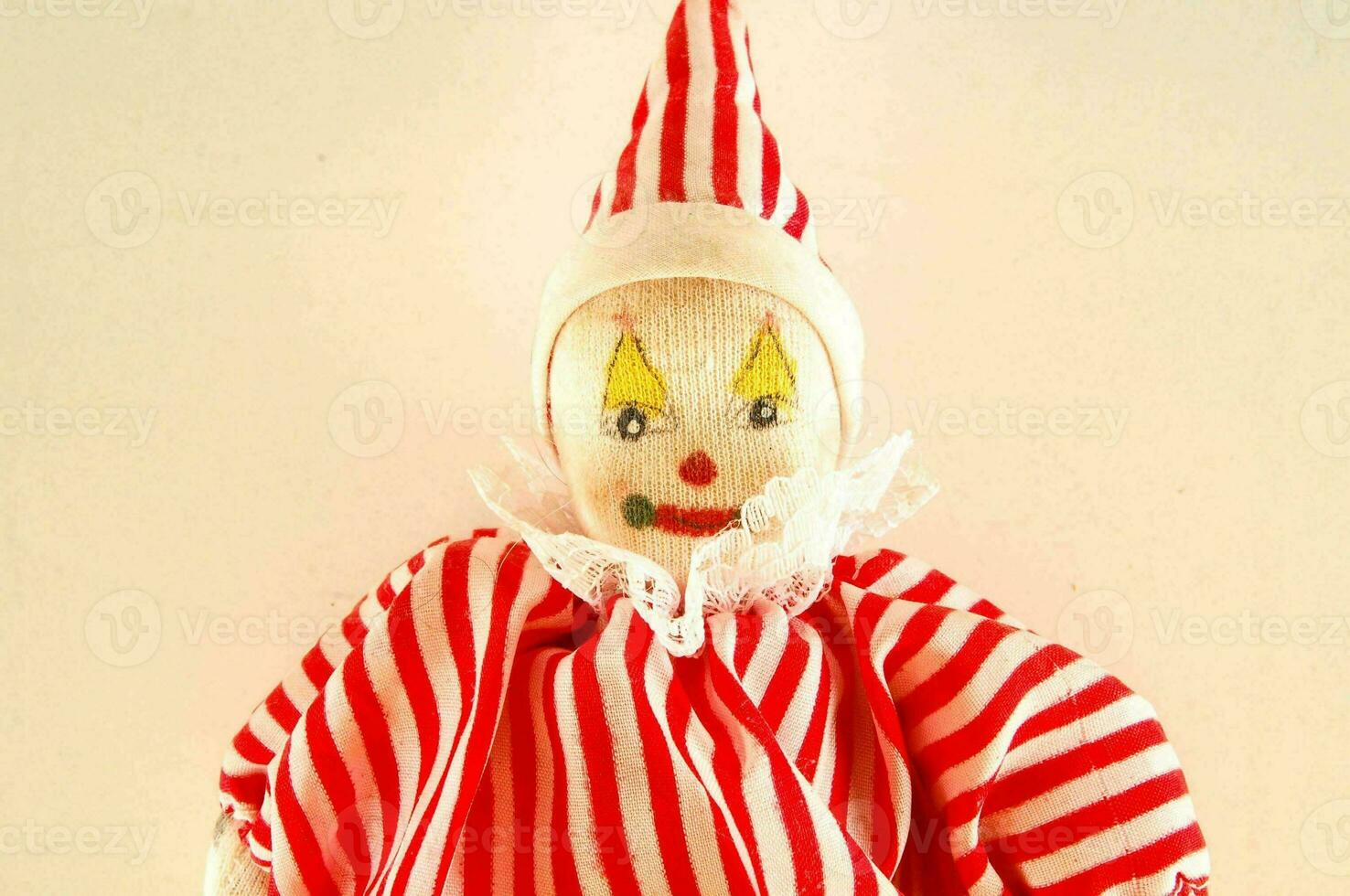 a red and white striped clown doll photo