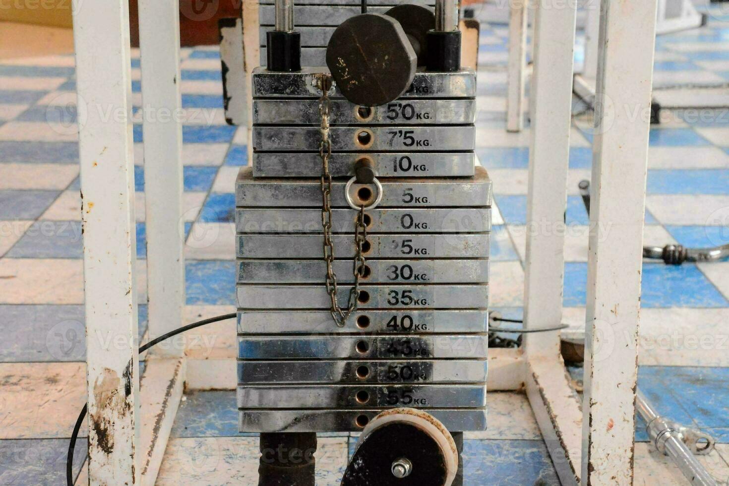 a stack of weights on a rack in a gym photo