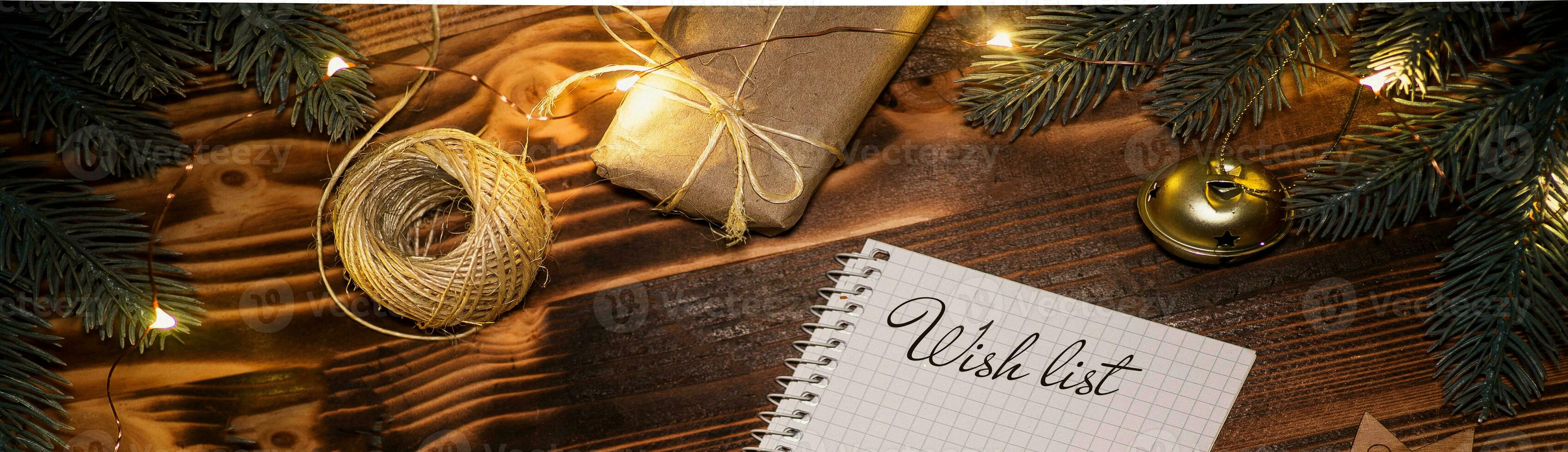 notebook with text WISH LIST on wooden background. Revealed diary pages with a plan for Christmas and the new 2022. Christmas concept flat lay photo