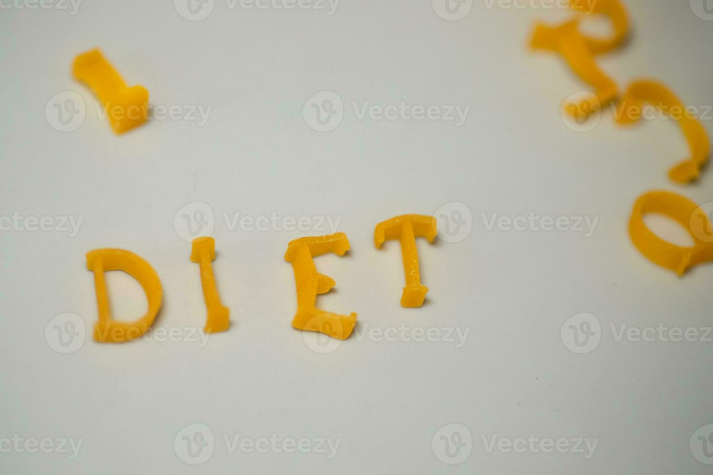 word DIET consists of edible letters. Pasta Diet Food. Pasta in form of letters on gray background. Proper nutrition concept. photo