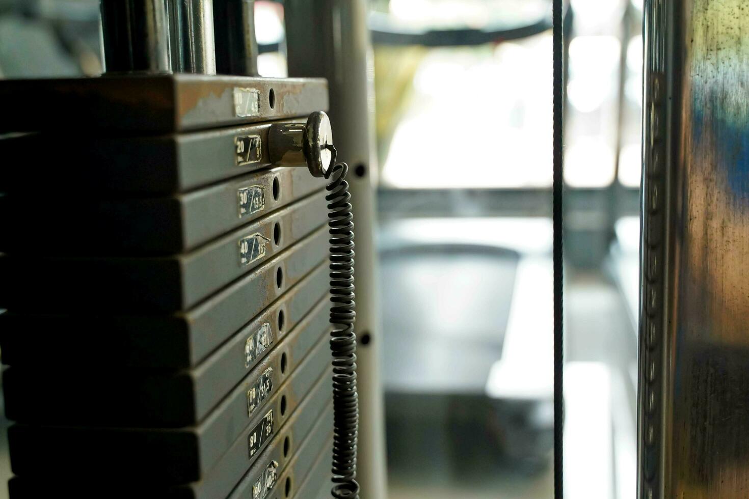 Closeup and crop weight lifting machine at fitness center on blurred background. photo