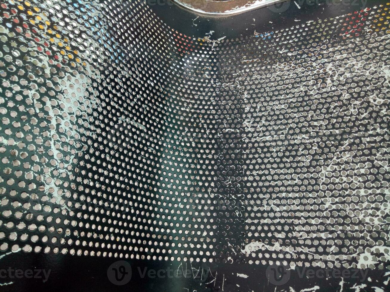 Texture of a black chair with lots of holes, peeling paint photo