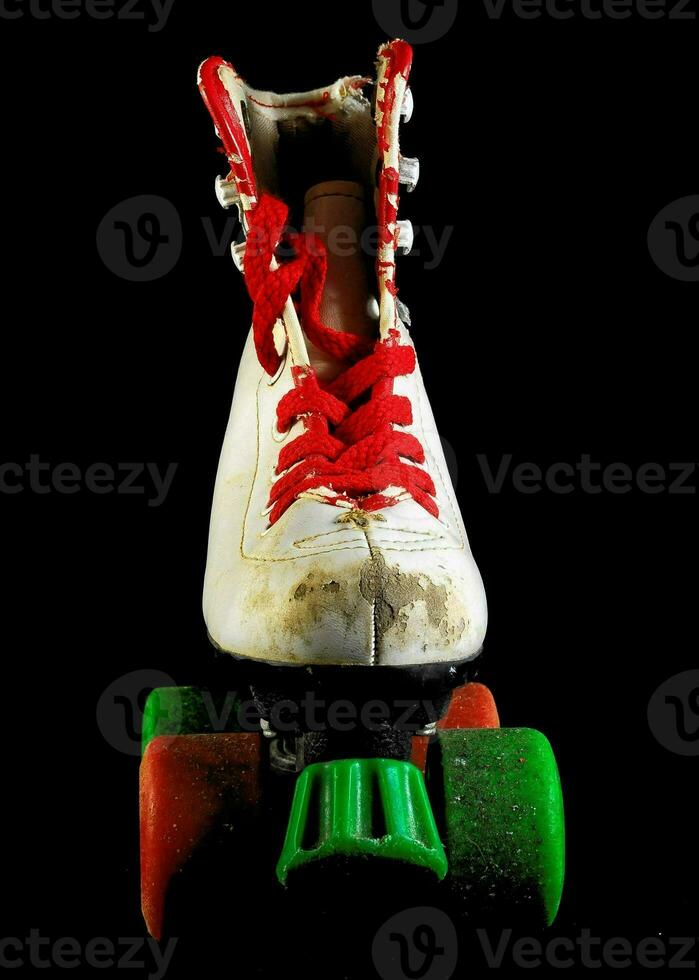 a pair of roller skates with green and red laces photo