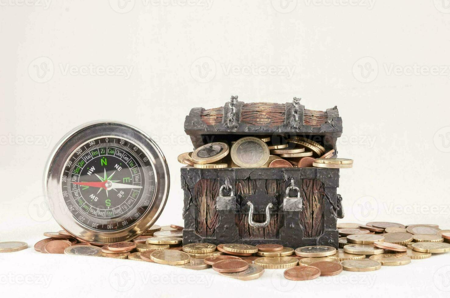 a wooden chest with coins and a compass photo