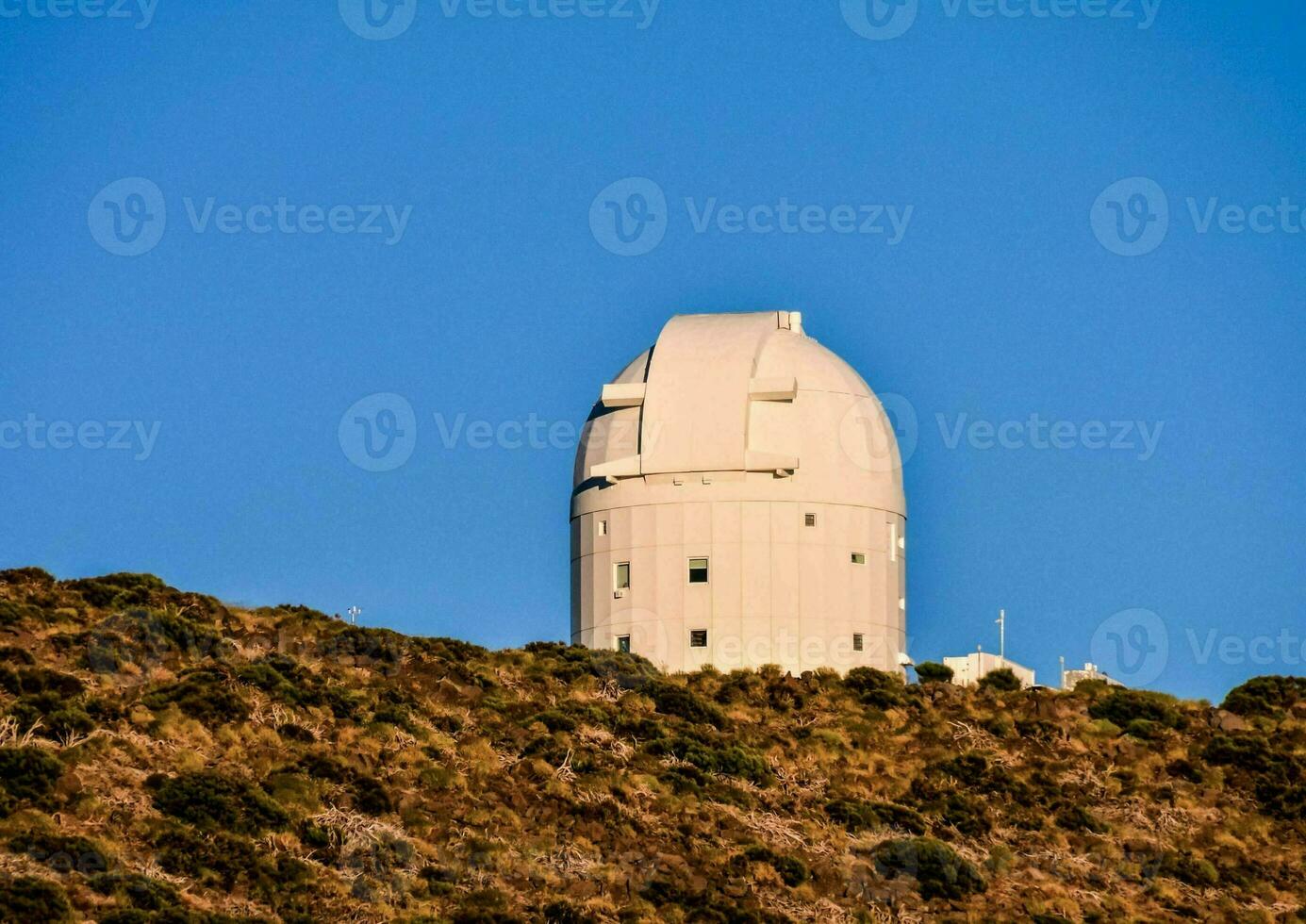 the observatory is on top of a hill with a blue sky photo