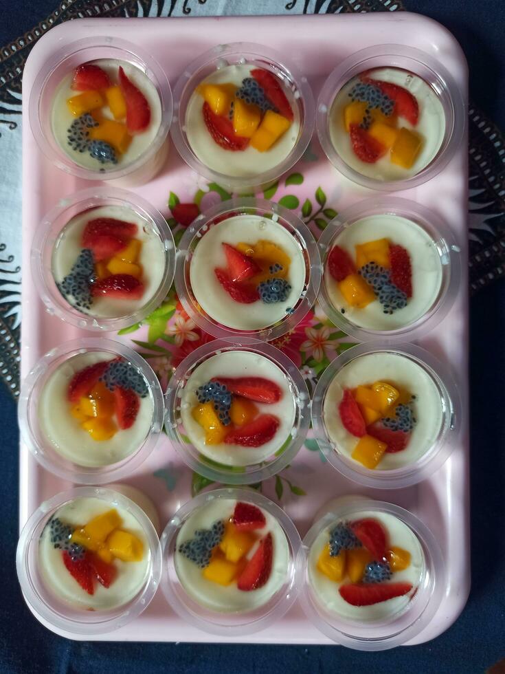 Milk pudding with fruit topping photo