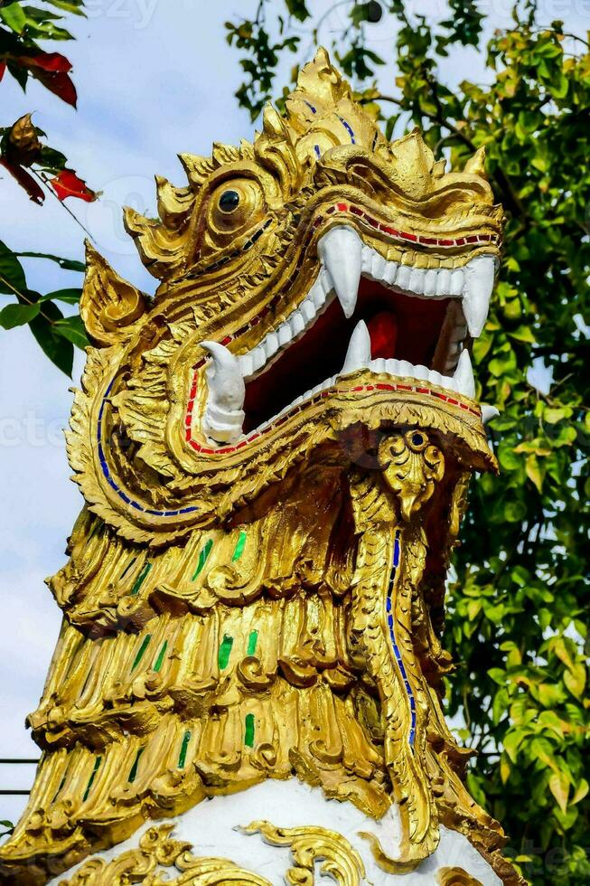 a golden lion statue with a large mouth photo