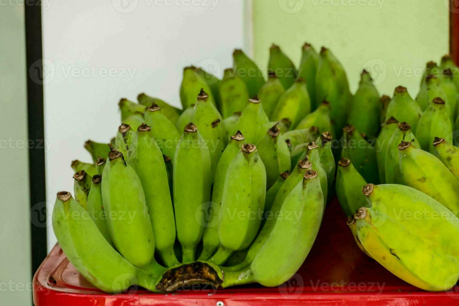 bananas are displayed on a red table photo