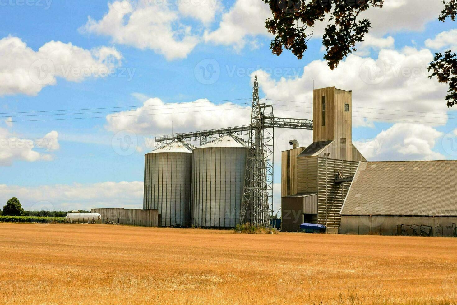 a large grain silo in a field photo