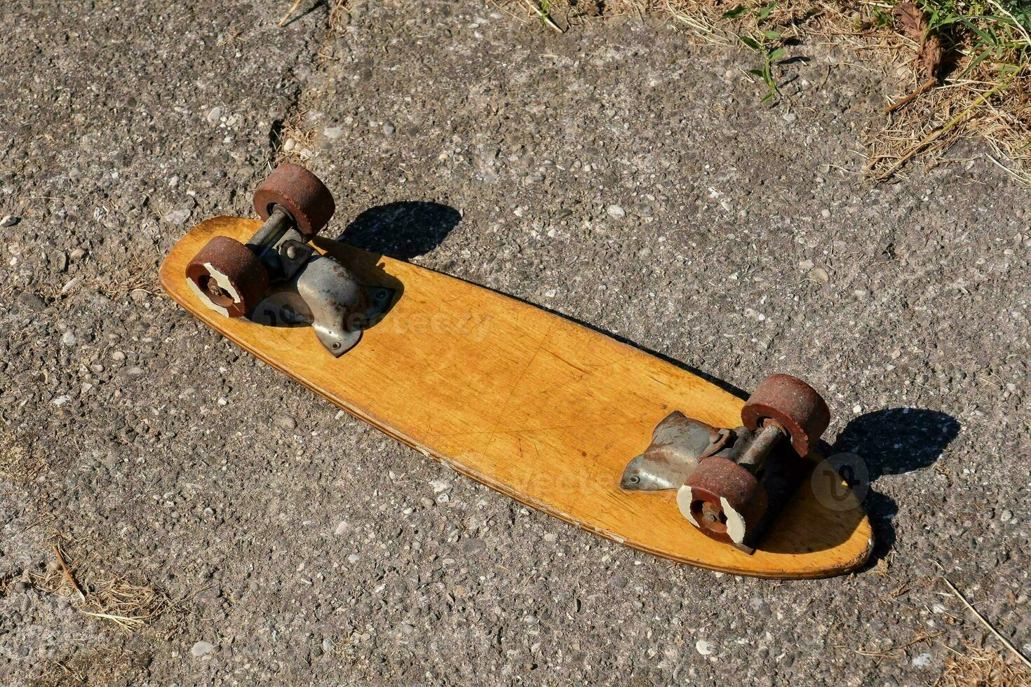 a skateboard laying on the ground with two wheels photo