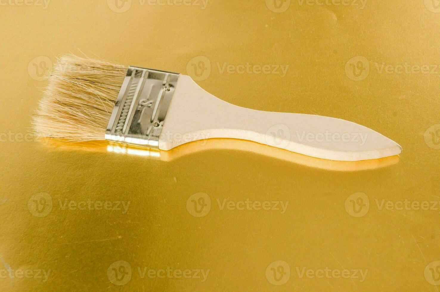 a brush on a gold surface photo
