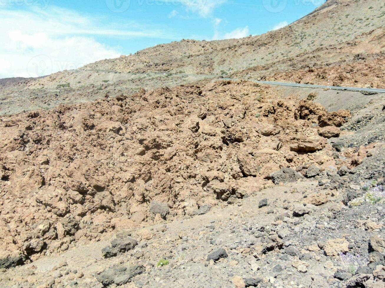a road that is going through a rocky area photo