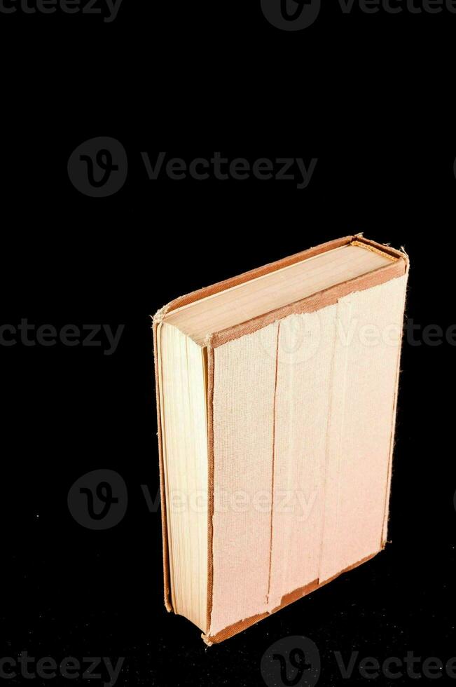 a book sitting on a black surface photo