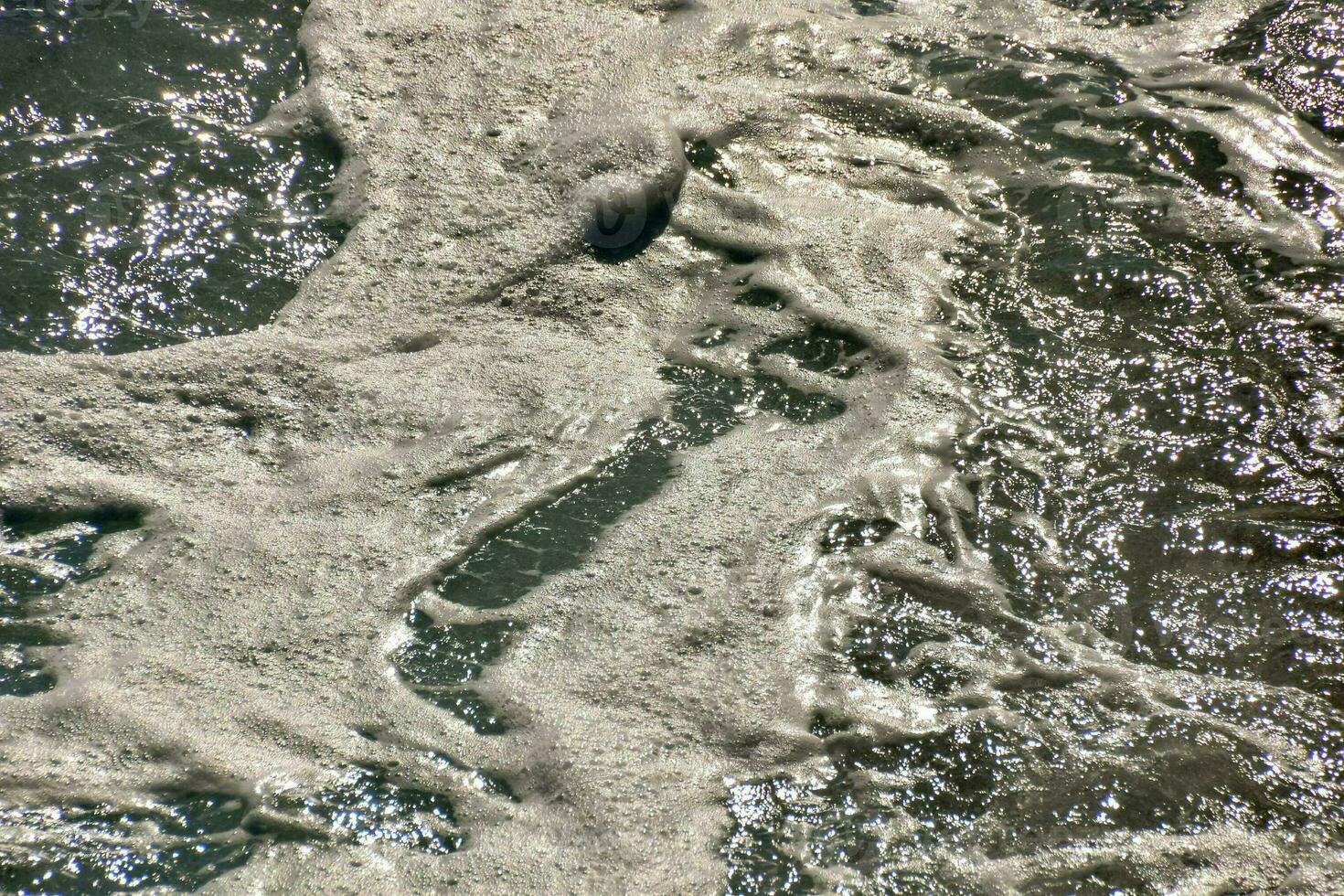 a wave with foam is seen in the ocean photo