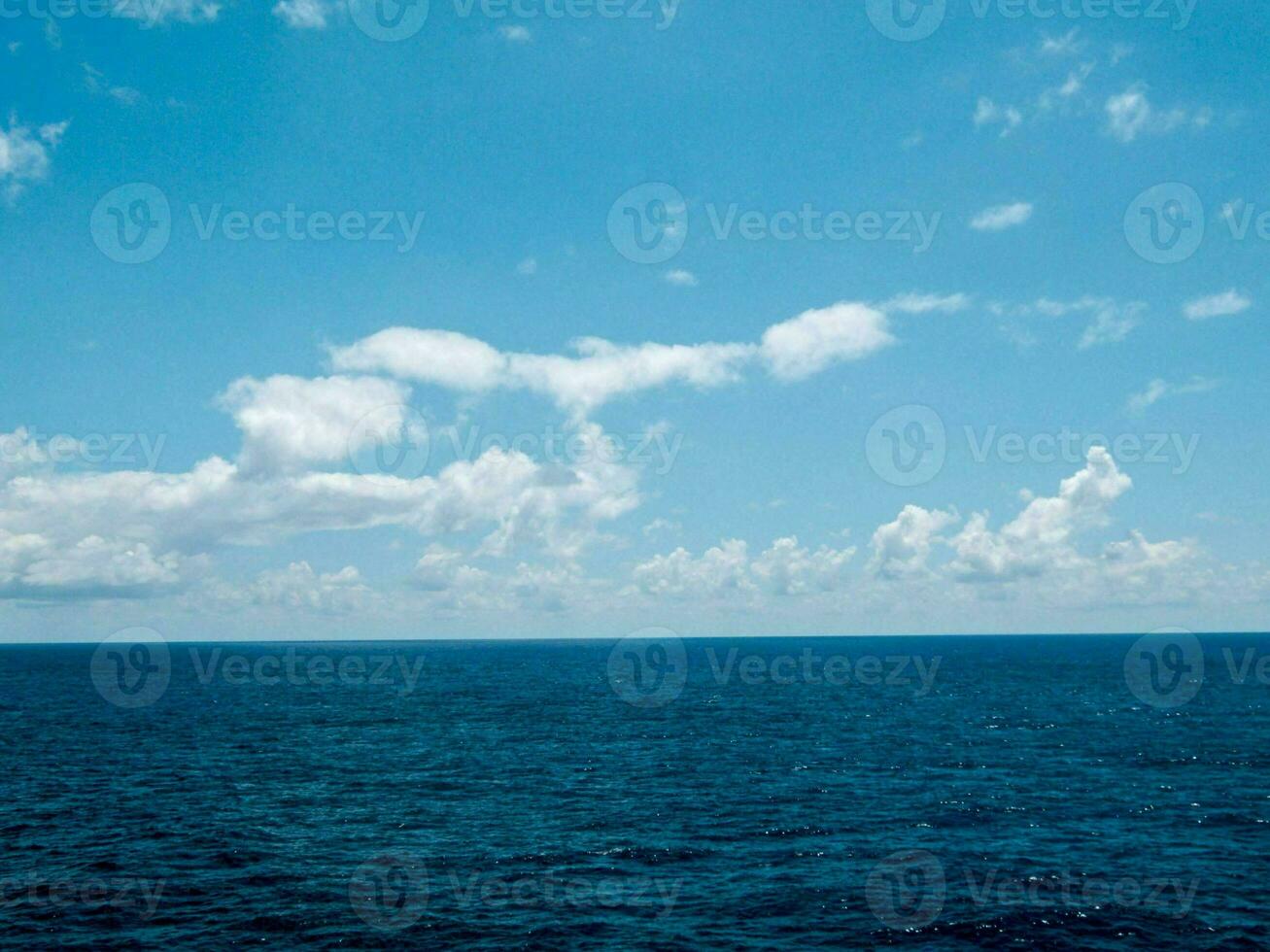 blue sky and clouds over the ocean photo