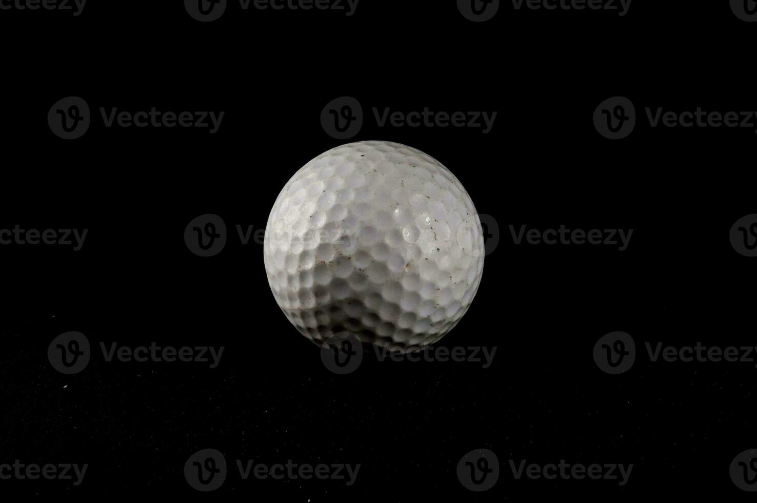 a golf ball on a black background photo