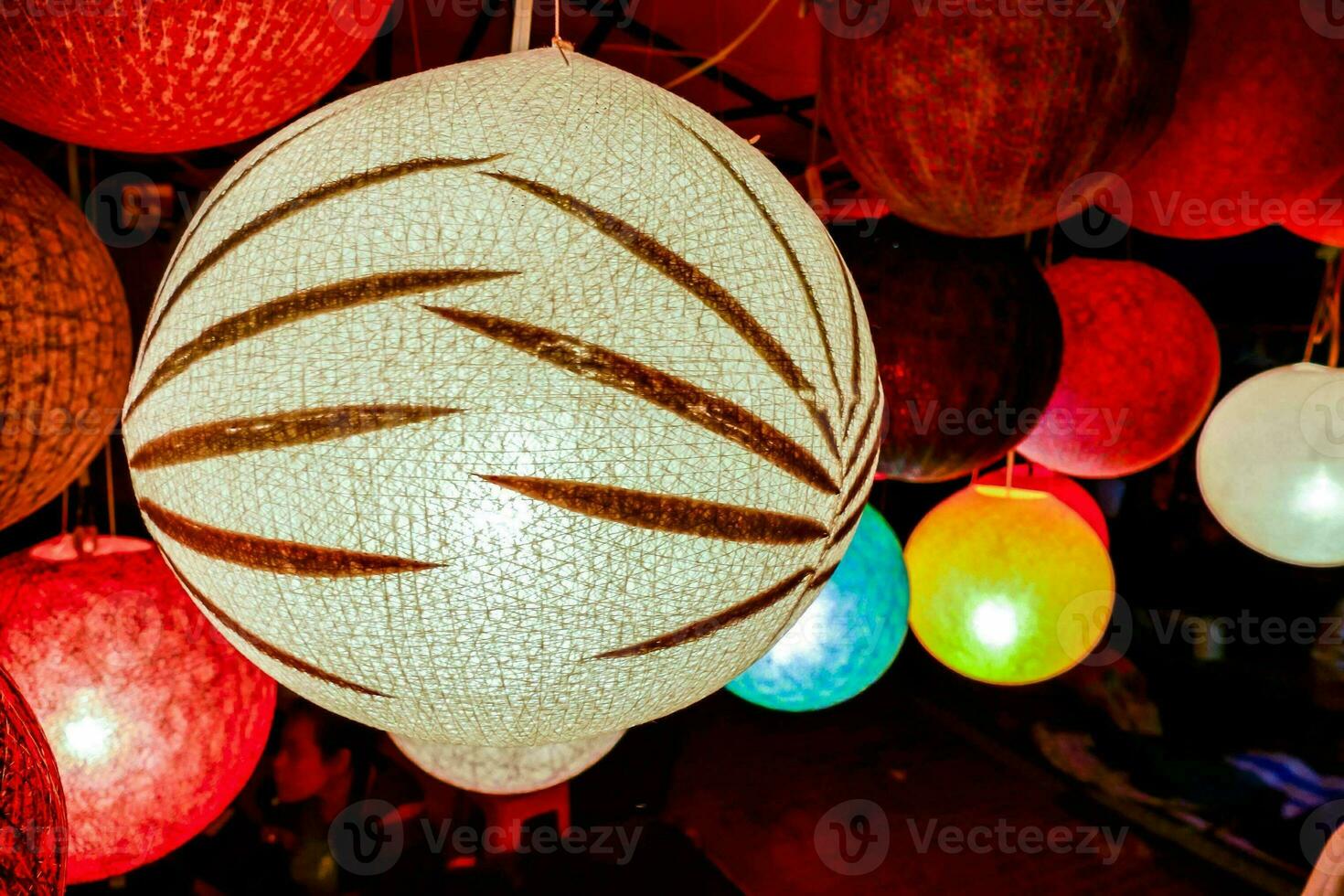 colorful paper lanterns hanging from a ceiling photo