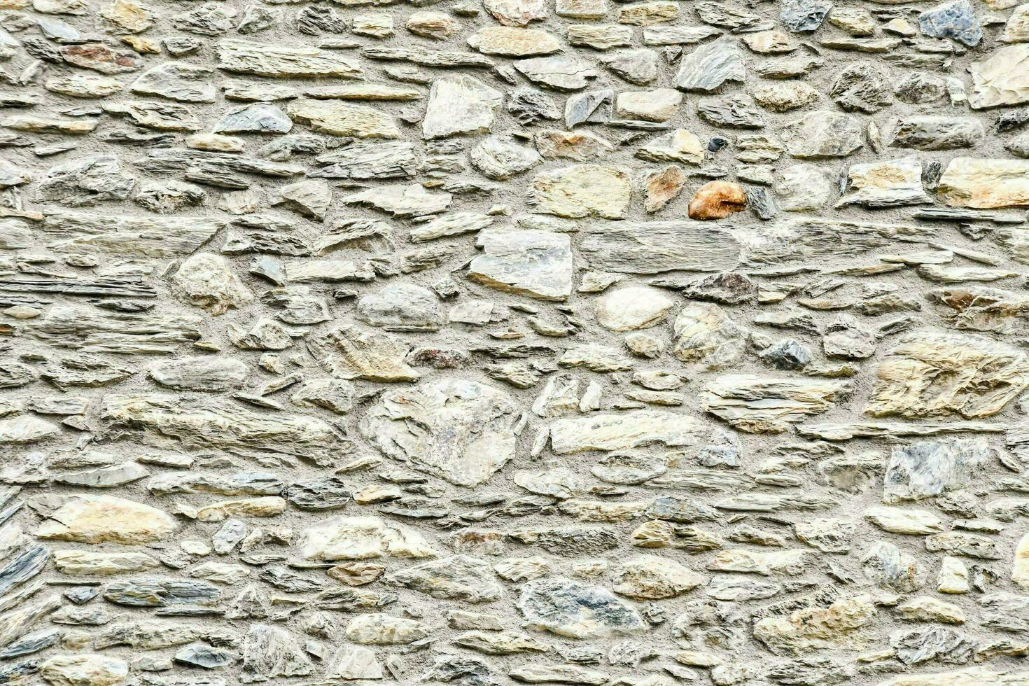 a stone wall with many different types of rocks photo