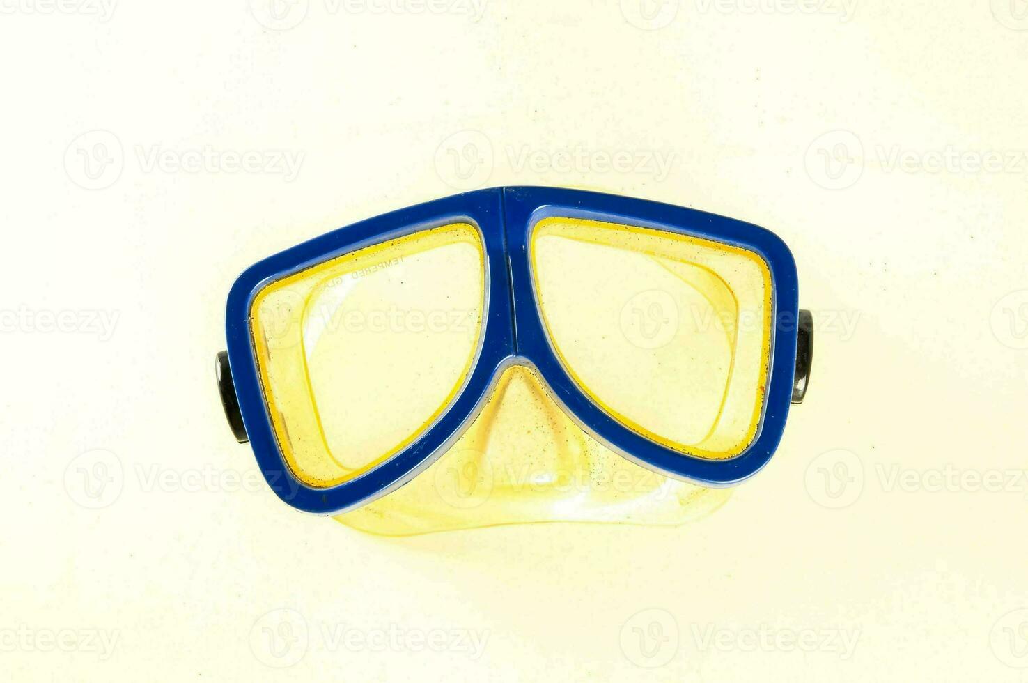 a yellow and blue diving mask on a white background photo