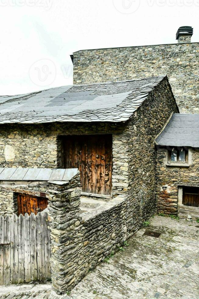 a stone building with wooden doors photo