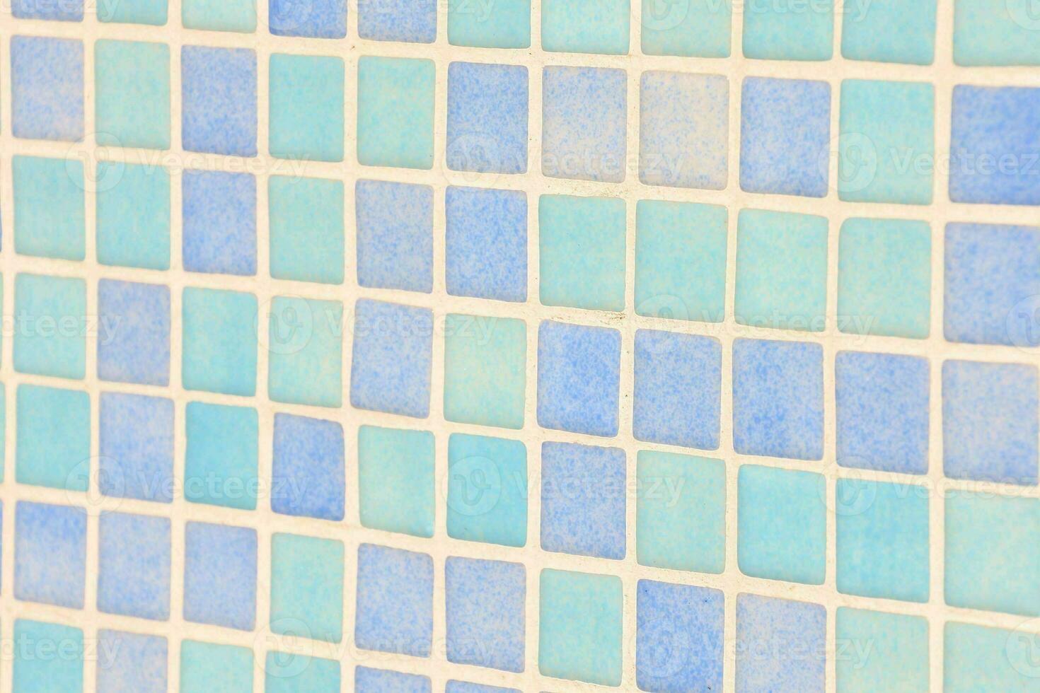 a tile wall with a blue square pattern photo