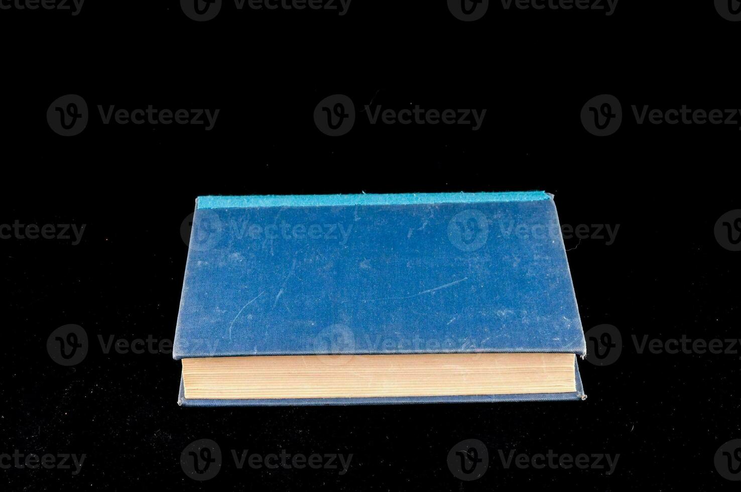 a blue book on a black background photo