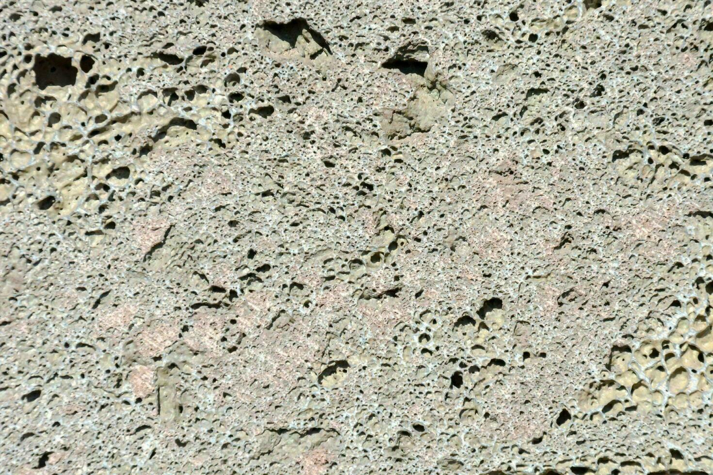 a close up of a concrete wall with holes photo