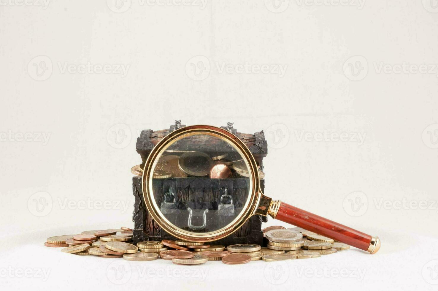 money and a magnifying glass on a white background photo