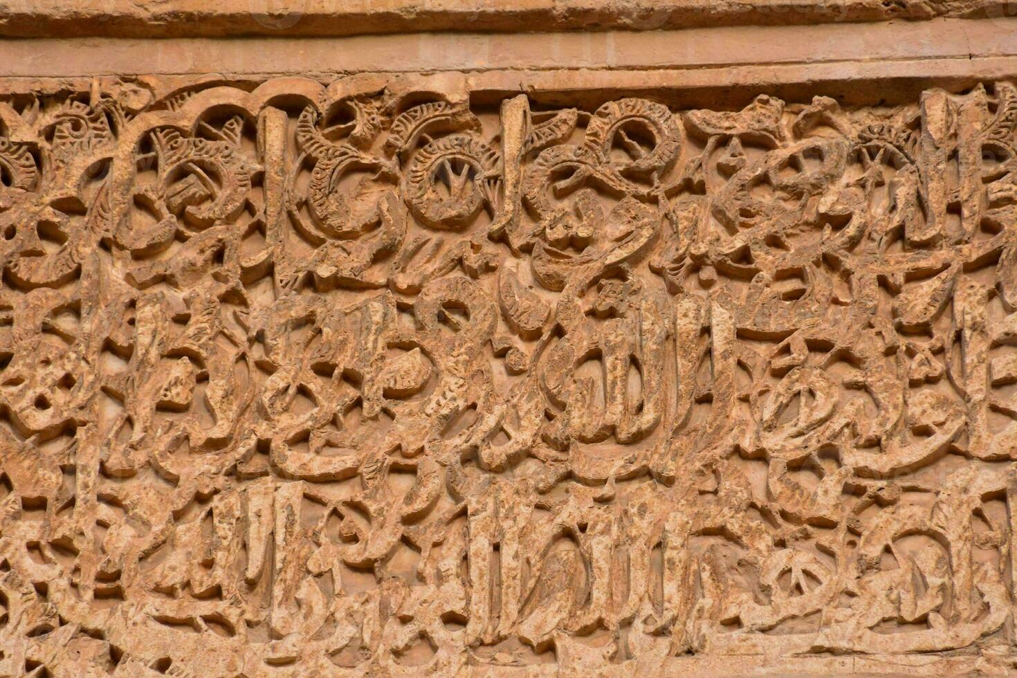 the intricate carvings on the wall of the mosque photo