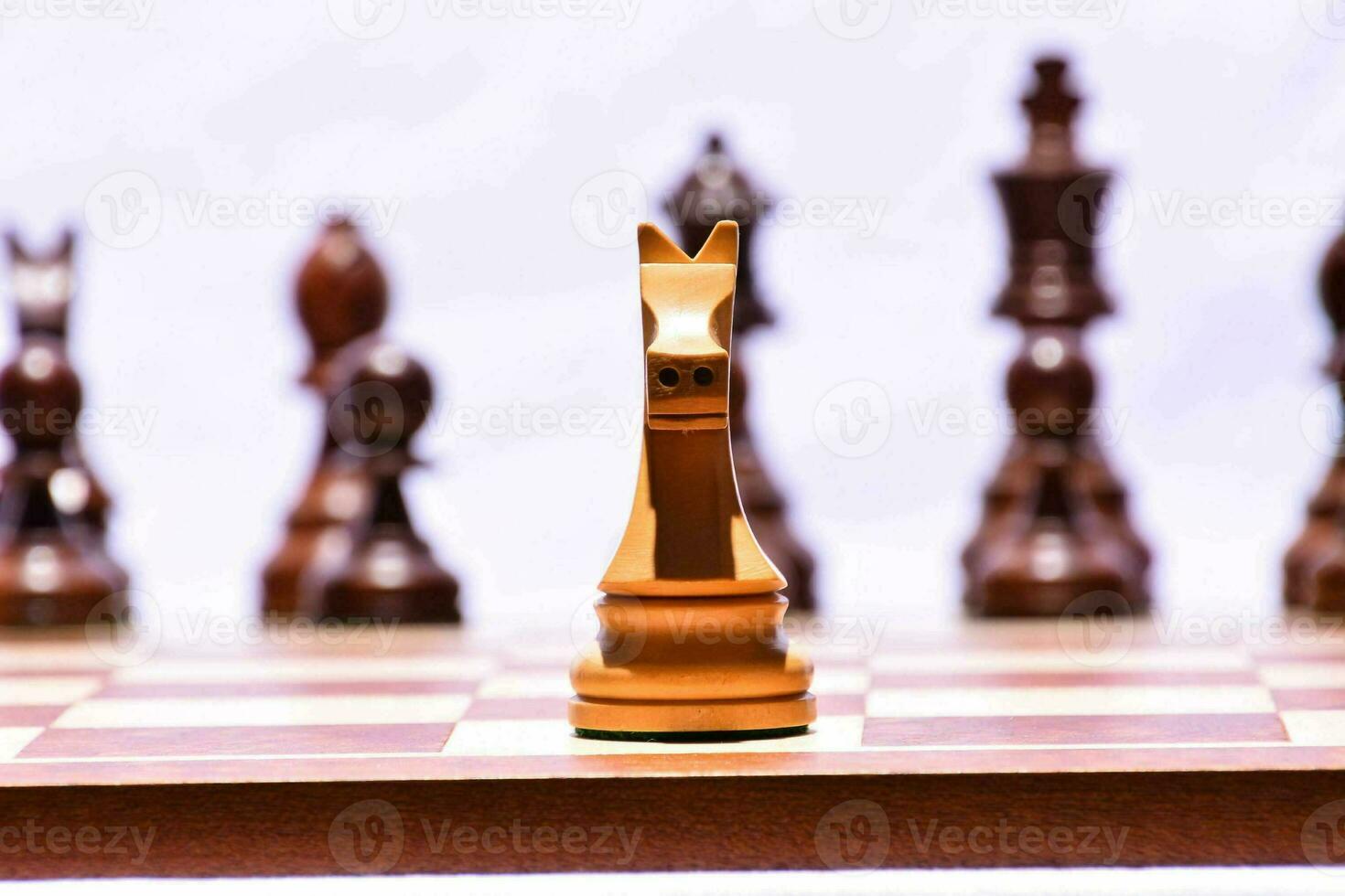 a chess board with a wooden chess piece in the middle photo