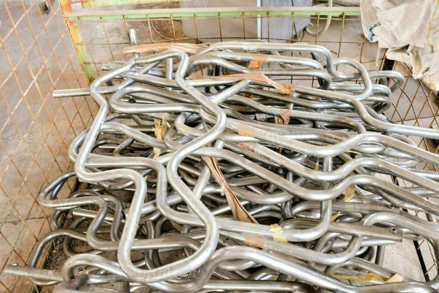 a basket full of metal pipes in a warehouse photo