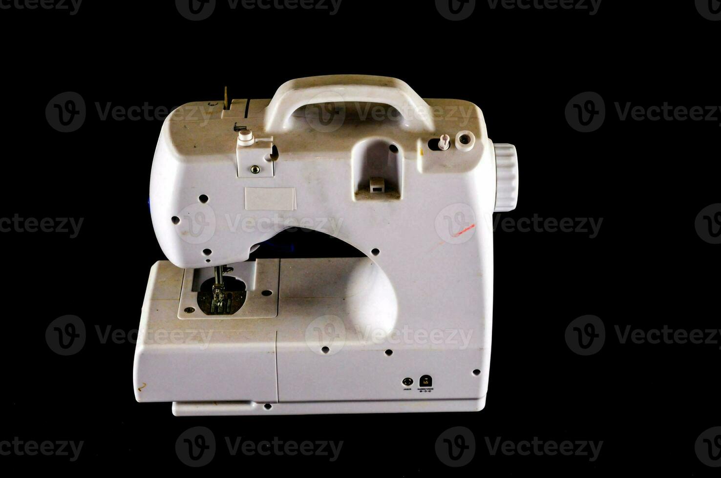 a white sewing machine on a black background photo