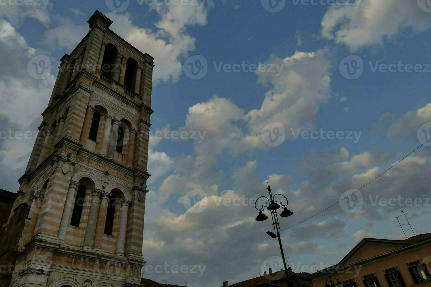 a tall tower against a cloudy blue sky photo